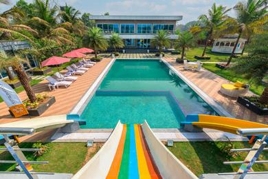 Villa SaffronStays Palm Paradise, Kalyan Khadavli - swimming pool with water slides, gazebo and indoor games