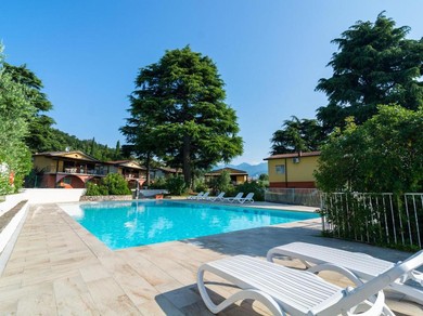 Holiday home Apartment on Lake Garda with pebble beach pier for boat three swimming pools
