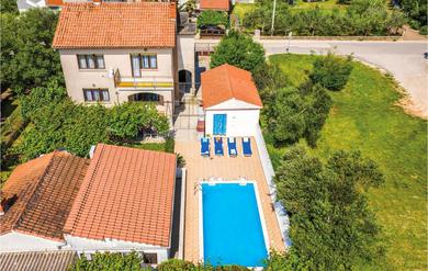 Holiday home Awesome home in Stinjan with 4 Bedrooms, WiFi and Outdoor swimming pool